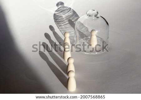 A person under transparent cap isolated from others standing in the queue Royalty-Free Stock Photo #2007568865