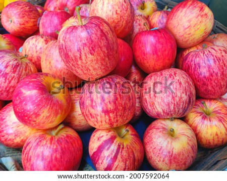 A jute basket full of hybrid apples kept for selling in the market