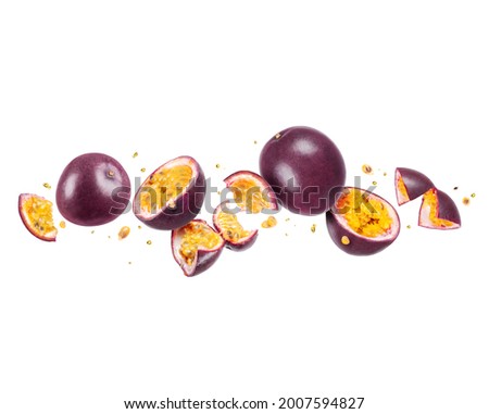 Whole and sliced passion fruit (passiflora) in the air on a white background Royalty-Free Stock Photo #2007594827