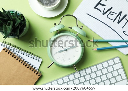 Events concept with alarm clock on green background