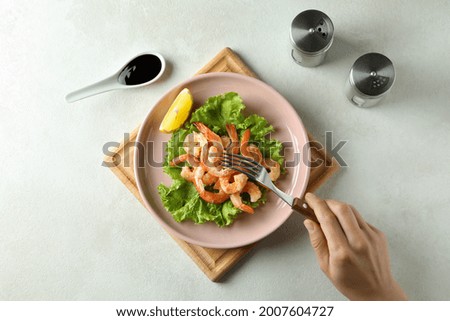 Concept of tasty eating with grilled shrimps on white textured table