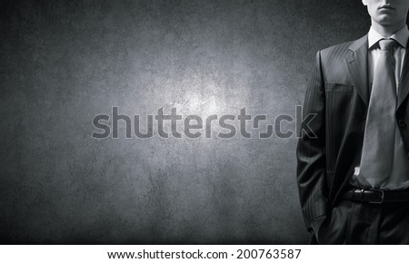 Close up of businessman with hands in pockets