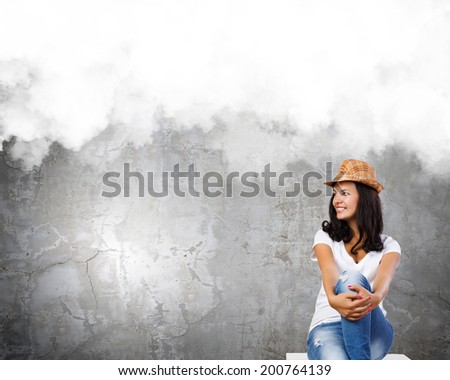 Young pretty lady in hat dreaming about future