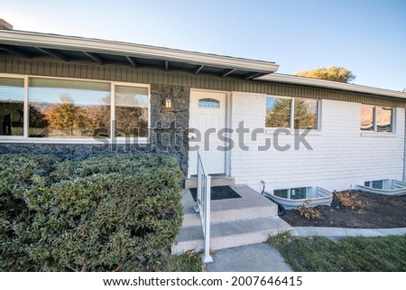 House exterior with white door, stones and brick walls Royalty-Free Stock Photo #2007646415
