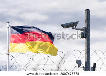 Germany  border, embassy, surveillance camera, barbed wire and Germany flag, concept picture	 Royalty-Free Stock Photo #2007693776