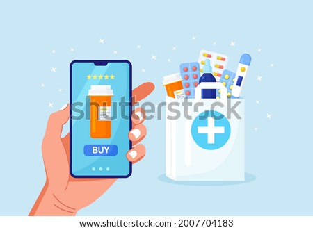 Human hand holding mobile phone for medicine online payment. Home delivery pharmacy service. Paper bag with pills bottle, medicines, drugs, thermometer inside. Medical assistance, health care concept Royalty-Free Stock Photo #2007704183