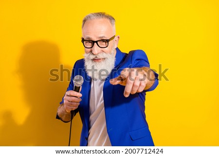 Portrait of attractive cheery man singing song pointing you event occasion isolated over bright yellow color background Royalty-Free Stock Photo #2007712424