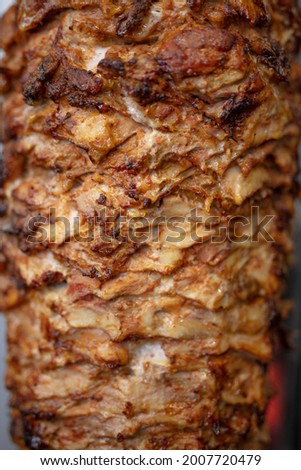 Traditional shawarma. Close Up picture of stacked meat roasting, shawarma