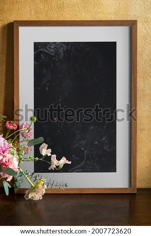 Wooden frame mockup by the flowers
