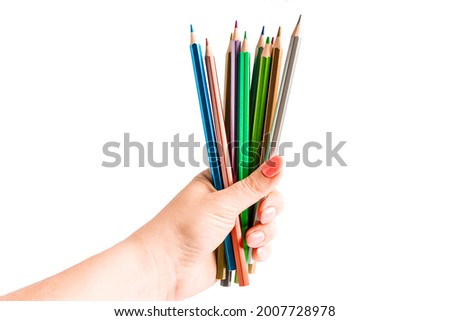 Set of colored pencils in hand on a white background. Back to school concept.