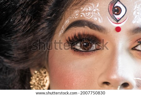 Indian female model in sari and face makeup to resemble Indian  Hindu goddess Uma or parvati is personification of beauty.Embodiment of Love, Power and Renewal.

 Royalty-Free Stock Photo #2007750830