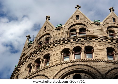 the old grain and exchange building in boston on a bright sunny day with a deep blue sky and soft white clouds