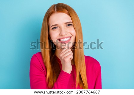 Photo of young girlish red head lady hand chin wear pink sweater isolated on vivid blue color background