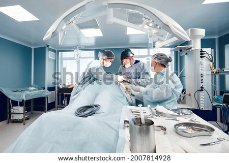 Operating room team of surgeons oncology plastic surgery Royalty-Free Stock Photo #2007814928
