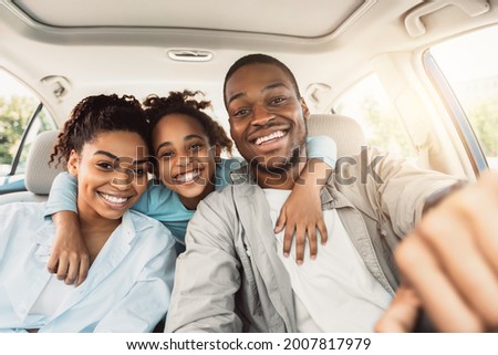 Joyful African American Family Hugging Sitting In Car During Summer Road Trip. Parents And Daughter Posing In New Auto Smiling To Camera. Transportation, New Automobile Concept Royalty-Free Stock Photo #2007817979