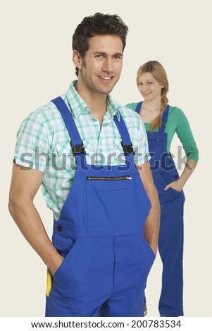 Man and woman in overall smiling