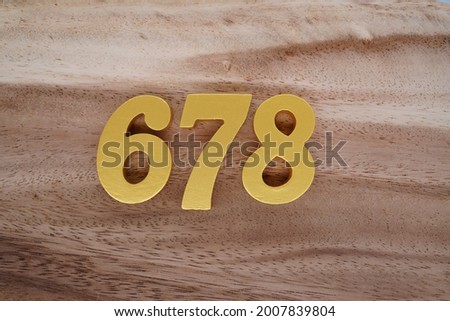 Gold numerals 678 on a dark brown to off-white wood pattern background.