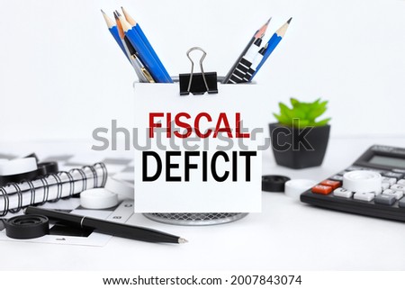 Fiscal Deficit. text attached to pencil case with crayons on white background