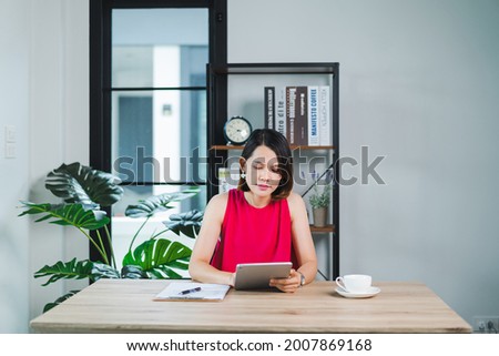 Asian businesswoman holding credit card and using laptop at home. Businessperson or entrepreneur working, online shopping, e-commerce, internet banking, working from home concept