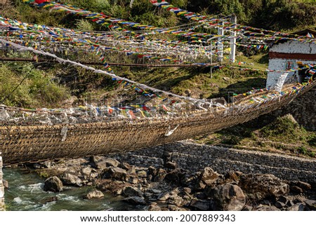 ancient holy iron bridge with many buddhist holy flags from flat angle image is taken at chaksam bridge tawang arunachal pradesh india.