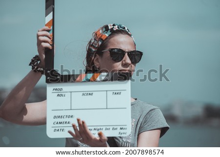 
Caucasian woman with a filming from a movie shoot