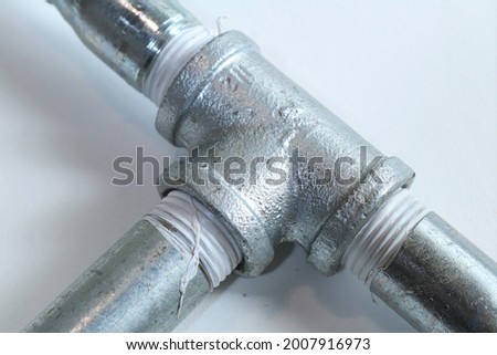 Galvanized T joint pipe. Galvanization is the process of applying a protective zinc coating to steel or iron, to prevent rusting Royalty-Free Stock Photo #2007916973