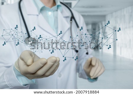 Doctor shows a medical network on a blurred background.