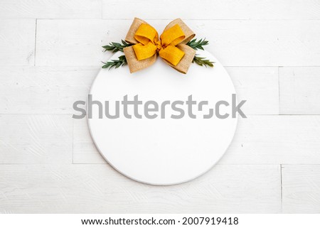 Blank white round wood sign on white backgound with yellow bow, fall door decor mockup 