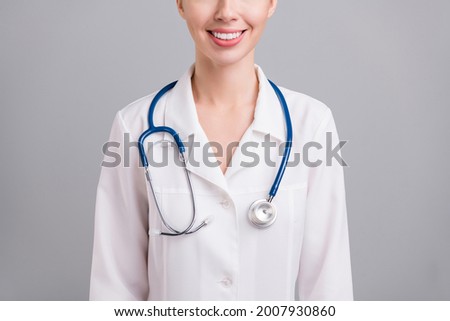 Cropped photo of sweet adorable young doc woman dressed white coat smiling isolated grey color background