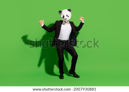 Photo of hipster absurd man dance disco wear panda mask black tux shoes isolated on green color background Royalty-Free Stock Photo #2007930881