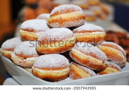Berliner donut in a bowl with powdered sugar