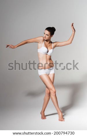 dancing ballerina in white studio