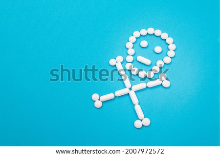 Dangerous Pharmaceutical Products or Unsafe Pills and Tablets - Skull or Death Symbol Made from White Pills Lying on Blue Background Royalty-Free Stock Photo #2007972572