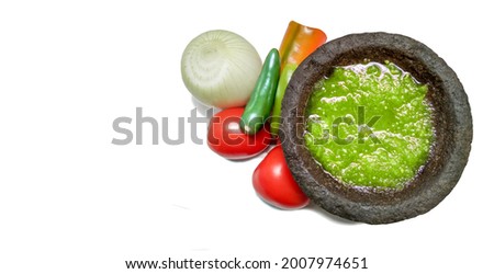 Traditional Mexican green sauce in molcajete, with copy space. Royalty-Free Stock Photo #2007974651