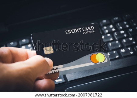 Credit card premium in the  hand with computer keyboard background