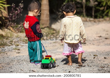 Kids playing naughty with toys trucks.