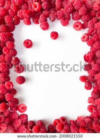Raspberries on a white background, isolated objects, green leaves, red summer berries, background for the text
