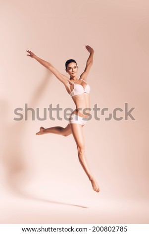sepia jumping woman in underwear