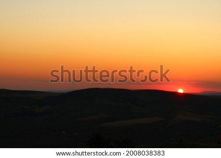 the setting sun behind the mountain.sunset