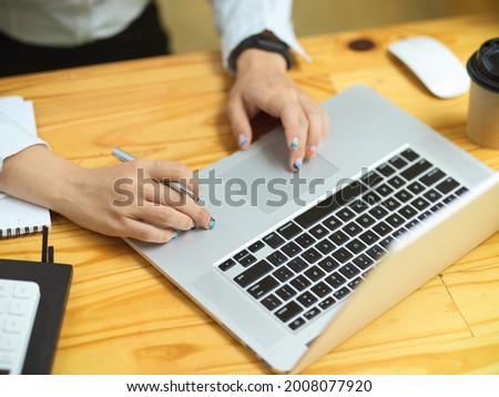 Business female hands using laptop, working on laptop, searching informations, browsing idea on website, close up