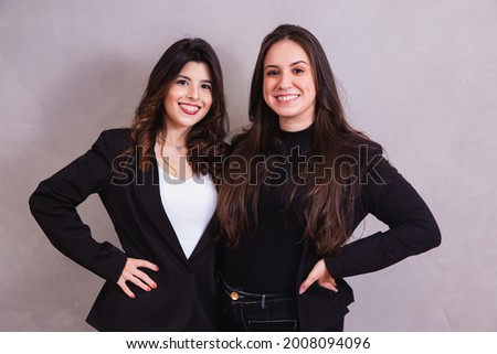 two business entrepreneur friends in grey background 