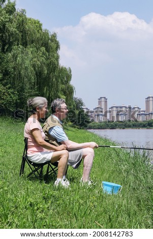 Old couple fishing by the lake high quality photo