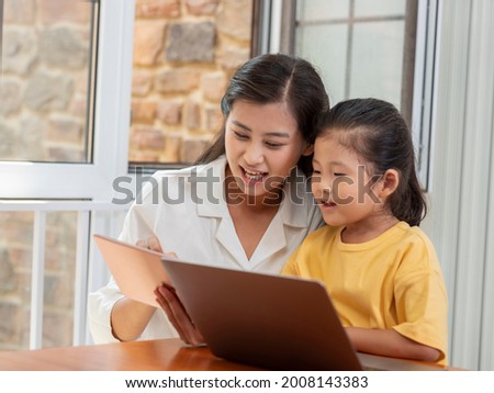 Happy mother and daughter use tablet high quality photo