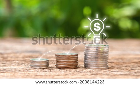 Coins on wooden table with money-saving icon on wooden background blurry background. saving money and investment concept.