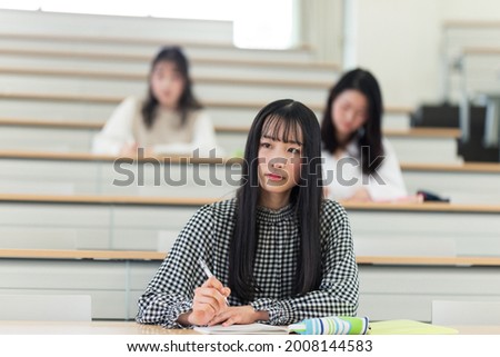University students taking lectures in the lecture room Royalty-Free Stock Photo #2008144583