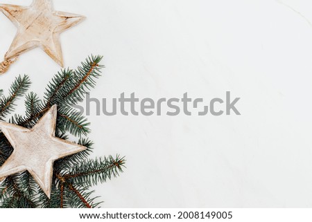 Wooden star ornament decorated pine tree background
