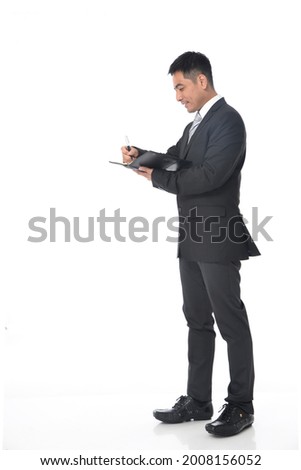Full length portrait of young businessman standing

