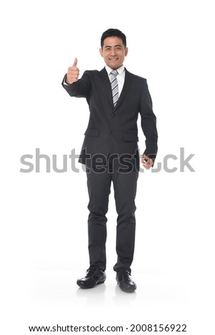 Full length portrait of young businessman standing with hand, thumbs up 


