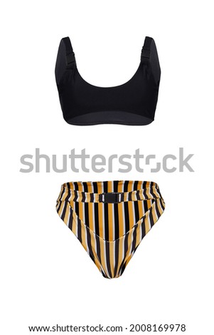Detail shot of two-piece swimsuit with snap buckles composed of black bra and striped high-waisted panties with false belt. Stylish swimming suit is isolated on the white background. Royalty-Free Stock Photo #2008169978