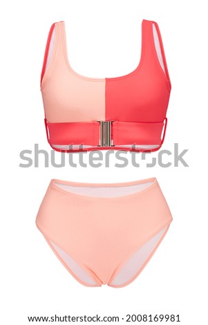 Detail shot of bright two-piece swimsuit composed of coral and pale pink bra with metal buckle and pale pink high-waisted panties. Stylish swimming suit is isolated on the white background. Royalty-Free Stock Photo #2008169981